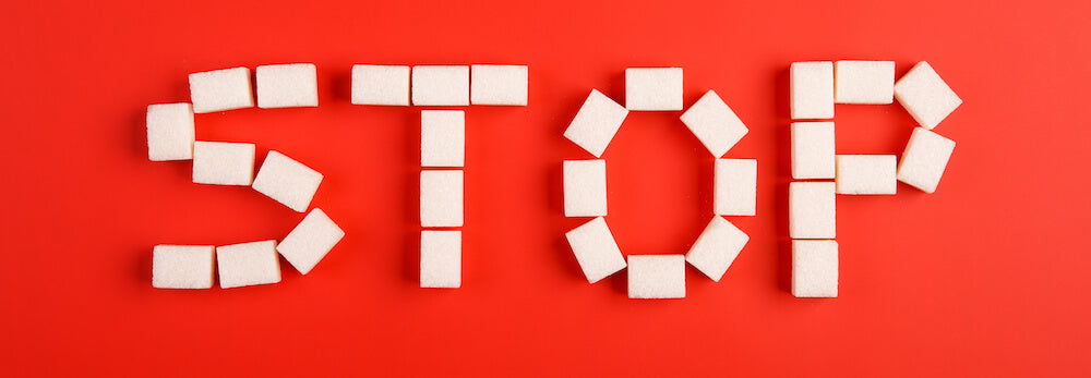 the word stop spelled out in sugar cubes on red background
