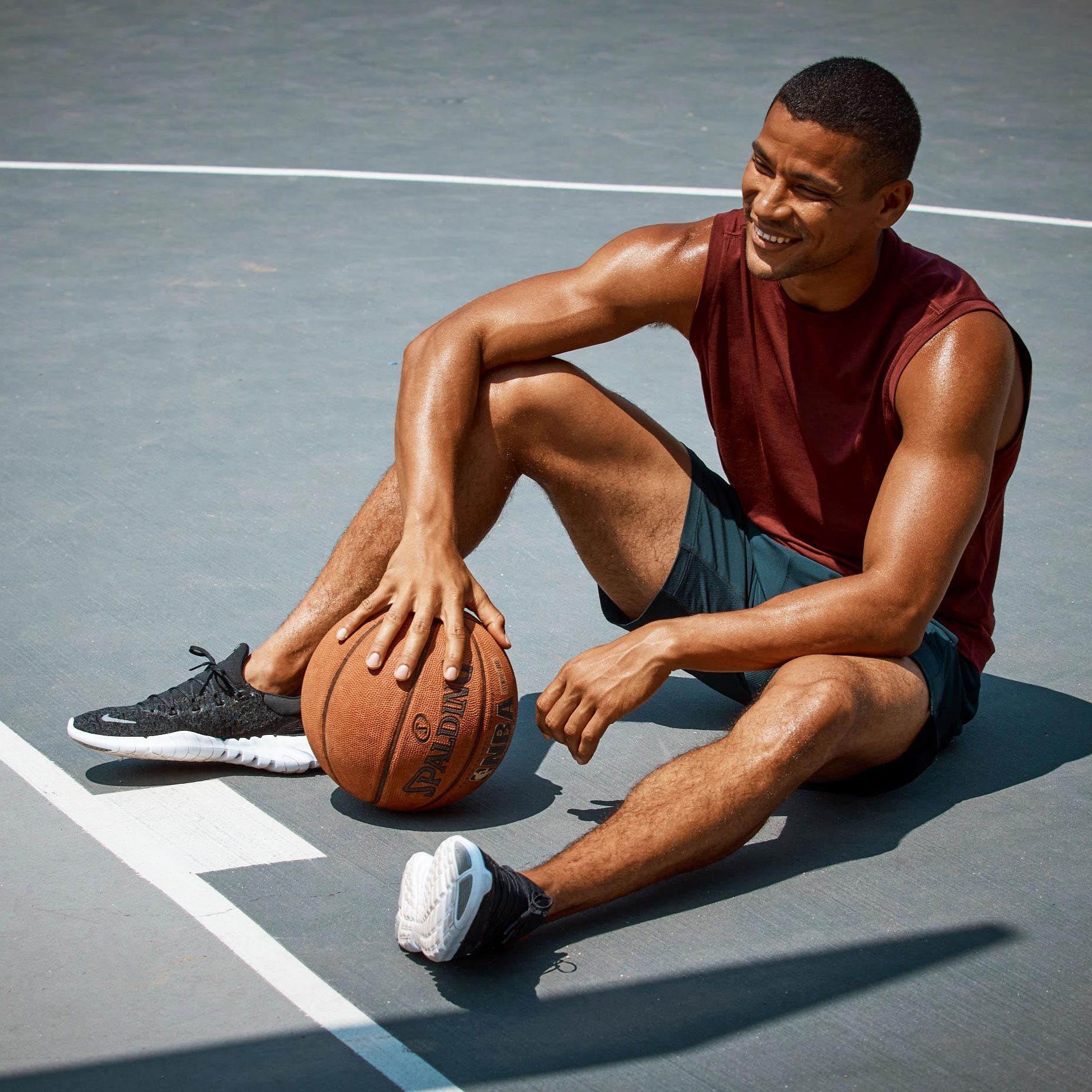 MPG male model taking a rest on a basketball court