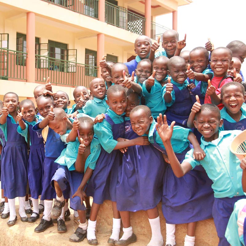 MCF children posing for the camera at Kamwokya Primary School in Kampala, Uganda