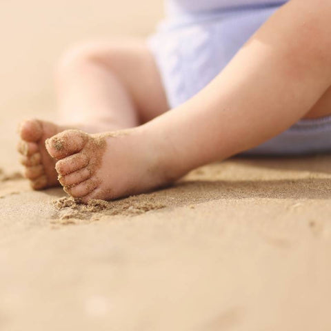 baby feet in sand sensory