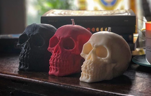 A trio of different coloured skull-shaped candles from <span data-mce-fragment="1"><a href="https://shop.blackmoonbotanica.co.uk/collections/candles-wax-melts/products/soy-skull-candle" data-mce-fragment="1" data-mce-href="https://shop.blackmoonbotanica.co.uk/collections/candles-wax-melts/products/soy-skull-candle">Black Moon Botanica</a></span>.