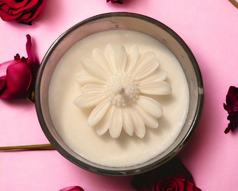 A handmade soy candle with a floral embellishment on top, from <span data-mce-fragment="1"><a href="https://www.etsy.com/uk/listing/1653475604/homemade-soy-wax-candle?click_key=9e5efbae829eae25d89ae6d9e2bdd225e7620676%3A1653475604&amp;click_sum=85a90d3b&amp;ref=shop_home_active_1" data-mce-fragment="1" data-mce-href="https://www.etsy.com/uk/listing/1653475604/homemade-soy-wax-candle?click_key=9e5efbae829eae25d89ae6d9e2bdd225e7620676%3A1653475604&amp;click_sum=85a90d3b&amp;ref=shop_home_active_1">Whiffy Wonders Wax</a></span>