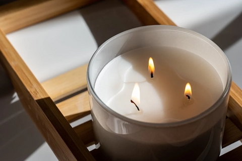 A lit triple-wicked candle that demonstrates the tunnelling effect when incorrectly burned. Source: Pexels