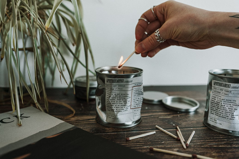 An artisanal, textured tin candle being lit with a match. Source: <span data-mce-fragment="1"><a href="https://unsplash.com/photos/person-holding-white-cigarette-stick-yu8b_ypXgjw" data-mce-href="https://unsplash.com/photos/person-holding-white-cigarette-stick-yu8b_ypXgjw" data-mce-fragment="1">Unsplash</a></span>.