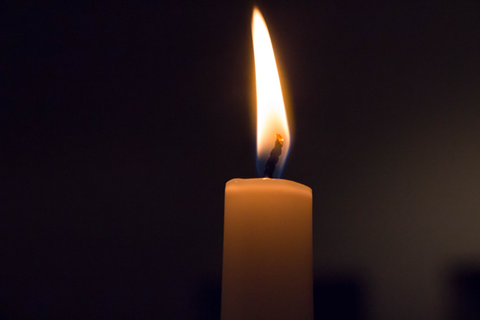 A close-up shot of a burning candle wick. Sourced from <span data-mce-fragment="1"><a href="https://unsplash.com/photos/white-candle-in-black-background-iDD-Bt42otQ" data-mce-href="https://unsplash.com/photos/white-candle-in-black-background-iDD-Bt42otQ" data-mce-fragment="1">Unsplash</a></span>.