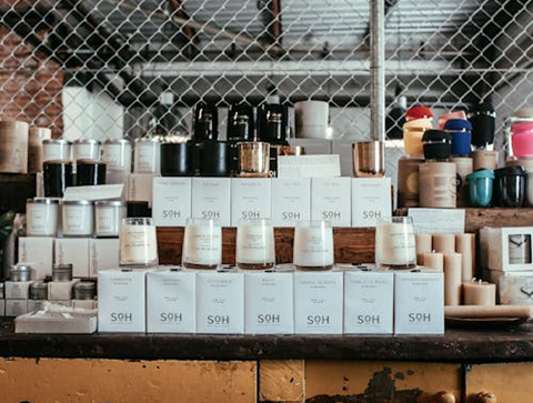 <span style="font-weight: 400;" data-mce-fragment="1" data-mce-style="font-weight: 400;">A shop display of scented candles staged on their packaging boxes. Source: </span><a href="https://www.pexels.com/photo/cabinet-full-of-candles-in-jars-5865151/" data-mce-fragment="1" data-mce-href="https://www.pexels.com/photo/cabinet-full-of-candles-in-jars-5865151/"><span style="font-weight: 400;" data-mce-fragment="1" data-mce-style="font-weight: 400;">Pexels</span></a>