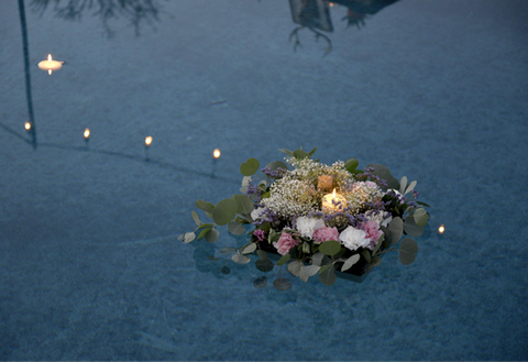 A candle surrounded flower bouquets floating in a calm body of water. Source: <span data-mce-fragment="1"><a href="https://unsplash.com/photos/pink-and-white-flowers-on-body-of-water-XzG1CK9ygxw" data-mce-fragment="1" data-mce-href="https://unsplash.com/photos/pink-and-white-flowers-on-body-of-water-XzG1CK9ygxw">unsplash</a></span>