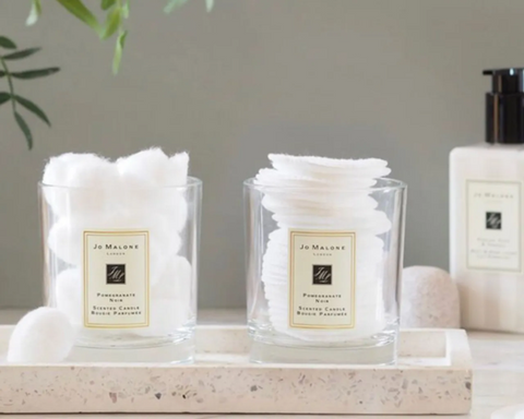 Jo Malone candle vessels, repurposed as bathroom storage to hold cotton pads. Sourced from <span data-mce-fragment="1"><a href="https://www.realhomes.com/design/how-to-reuse-a-candle-jar" data-mce-fragment="1" data-mce-href="https://www.realhomes.com/design/how-to-reuse-a-candle-jar">Real Homes</a></span>.