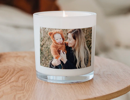 A candle with a photograph of a mum and baby on the label from <span data-mce-fragment="1"><a href="https://www.yoursurprise.ie/home-and-lifestyle/home-decoration/personalised-candles" data-mce-fragment="1" data-mce-href="https://www.yoursurprise.ie/home-and-lifestyle/home-decoration/personalised-candles">YourSurprise</a></span>.