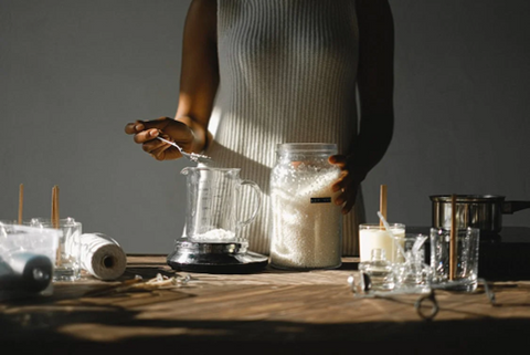 <span style="font-weight: 400;" data-mce-fragment="1" data-mce-style="font-weight: 400;"> woman tipping wax into a beaker to make candles. Source: </span><a href="https://www.pexels.com/photo/crop-black-woman-pouring-wax-into-beaker-5760813/" data-mce-fragment="1" data-mce-href="https://www.pexels.com/photo/crop-black-woman-pouring-wax-into-beaker-5760813/"><span style="font-weight: 400;" data-mce-fragment="1" data-mce-style="font-weight: 400;">Pexels</span></a><span style="font-weight: 400;" data-mce-fragment="1" data-mce-style="font-weight: 400;">.</span>