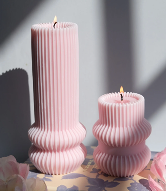 <span style="font-weight: 400;" data-mce-fragment="1" data-mce-style="font-weight: 400;">A product image of two sculpture striped pillar candles in pink. Sourced from </span><a href="https://interludecandles.com/products/striped-pillar-candle?variant=42642321998001&amp;currency=GBP&amp;utm_medium=product_sync&amp;utm_source=google&amp;utm_content=sag_organic&amp;utm_campaign=sag_organic&amp;gclid=Cj0KCQiA7OqrBhD9ARIsAK3UXh3bszacsAAnlfNzowSNAxiTqZ016MCI6zTDRvX8UjRR50Z9nTMq7KEaAv68EALw_wcB" data-mce-fragment="1" data-mce-href="https://interludecandles.com/products/striped-pillar-candle?variant=42642321998001&amp;currency=GBP&amp;utm_medium=product_sync&amp;utm_source=google&amp;utm_content=sag_organic&amp;utm_campaign=sag_organic&amp;gclid=Cj0KCQiA7OqrBhD9ARIsAK3UXh3bszacsAAnlfNzowSNAxiTqZ016MCI6zTDRvX8UjRR50Z9nTMq7KEaAv68EALw_wcB"><span style="font-weight: 400;" data-mce-fragment="1" data-mce-style="font-weight: 400;">Interlude</span></a><span style="font-weight: 400;" data-mce-fragment="1" data-mce-style="font-weight: 400;">.</span>