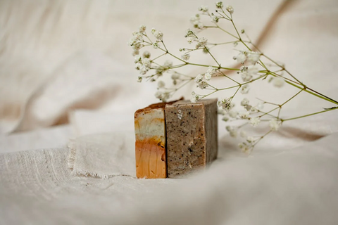 Two blocks of artisan soap with Baby’s Breath flowers balancing on them. Sourced from <span data-mce-fragment="1"><a href="https://www.pexels.com/photo/bar-soaps-beside-baby-s-breath-flowers-5420576/" data-mce-fragment="1" data-mce-href="https://www.pexels.com/photo/bar-soaps-beside-baby-s-breath-flowers-5420576/">Pexels</a></span>.