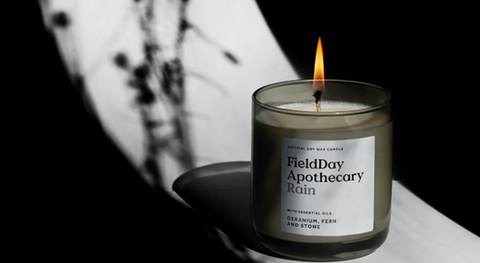 A moody and atmospheric product image of <span data-mce-fragment="1"><a href="https://fielddayireland.co.uk/products/rain-candle" data-mce-fragment="1" data-mce-href="https://fielddayireland.co.uk/products/rain-candle">FieldDay’s ‘Rain’ candle</a></span>.