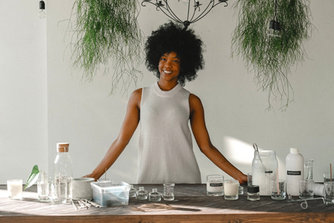 A woman with candle-making supplies lined up on a table, waiting to deliver a candle-making class. Sourced from <span data-mce-fragment="1"><a href="https://www.pexels.com/photo/delighted-black-woman-standing-at-table-in-workshop-for-making-candles-5761122/" data-mce-fragment="1" data-mce-href="https://www.pexels.com/photo/delighted-black-woman-standing-at-table-in-workshop-for-making-candles-5761122/">Pexels</a></span>.