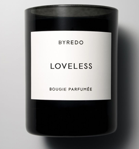 A designer candle in a black vessel with a white label that reads ‘Loveless’, from <span data-mce-fragment="1"><a href="https://www.byredo.com/us_en/loveless-candle-240g" data-mce-fragment="1" data-mce-href="https://www.byredo.com/us_en/loveless-candle-240g">Byredo</a></span>.