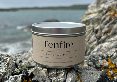 A Coastal Mist tin candle among a rocky coastline setting from <span data-mce-fragment="1"><a href="https://www.tenfire.co.uk/products/coastal-mist-soy-wax-candle-tin" data-mce-fragment="1" data-mce-href="https://www.tenfire.co.uk/products/coastal-mist-soy-wax-candle-tin">Tenfire</a></span>.