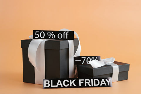 A graphic of black gifts with white ribbons and a Black Friday sign. Sourced from Pexels.