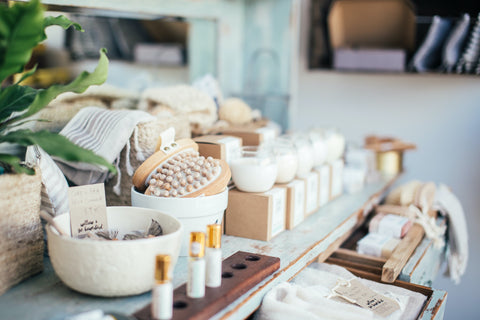 An organised shop display of candles and other self-care items. Sourced from Pexels.