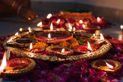 A shrine of deep red traditional Diya candles lit up for Diwali. Sourced from Pexels.