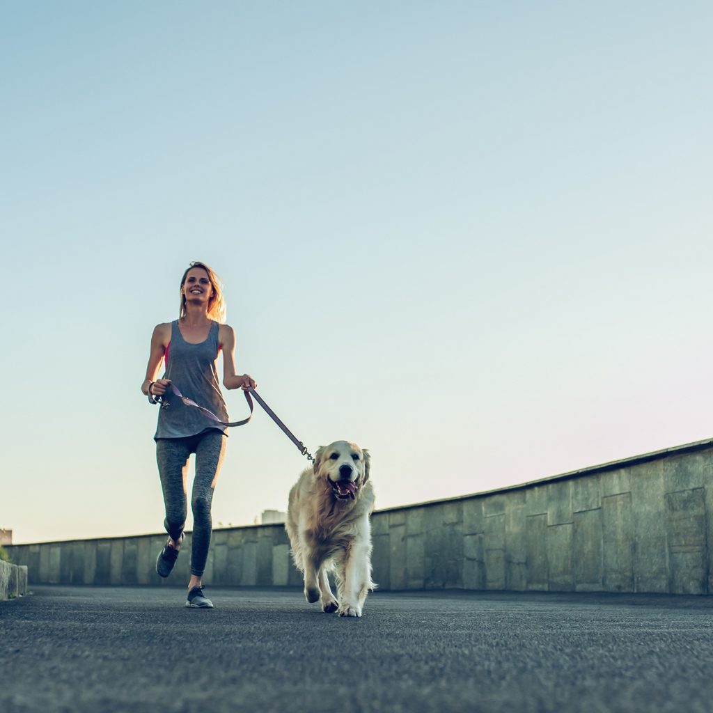 a women is running with her dog