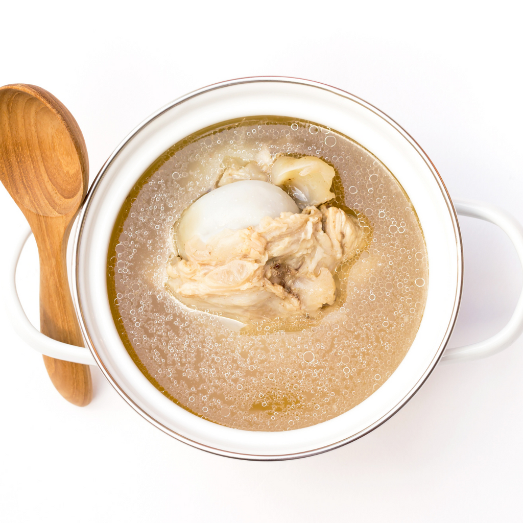 a bowl of bone broth is sitting on the kitchen counter 