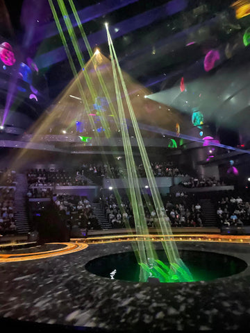 Laser beams shine down into the water pit on stage