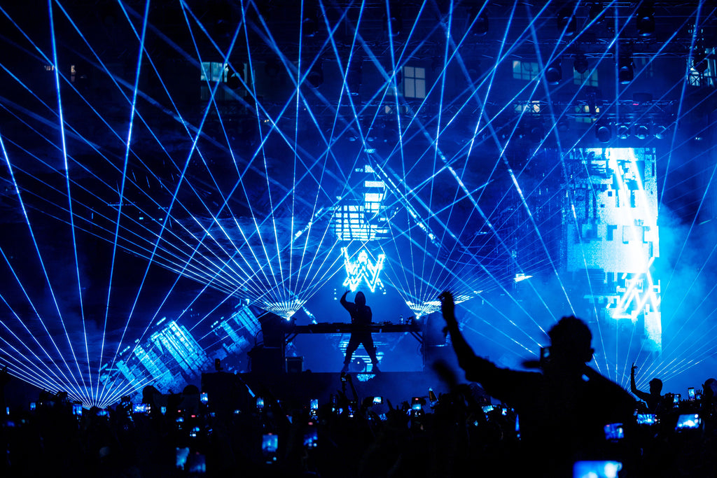 DJ Alan Walker performs for crowd with laser show.