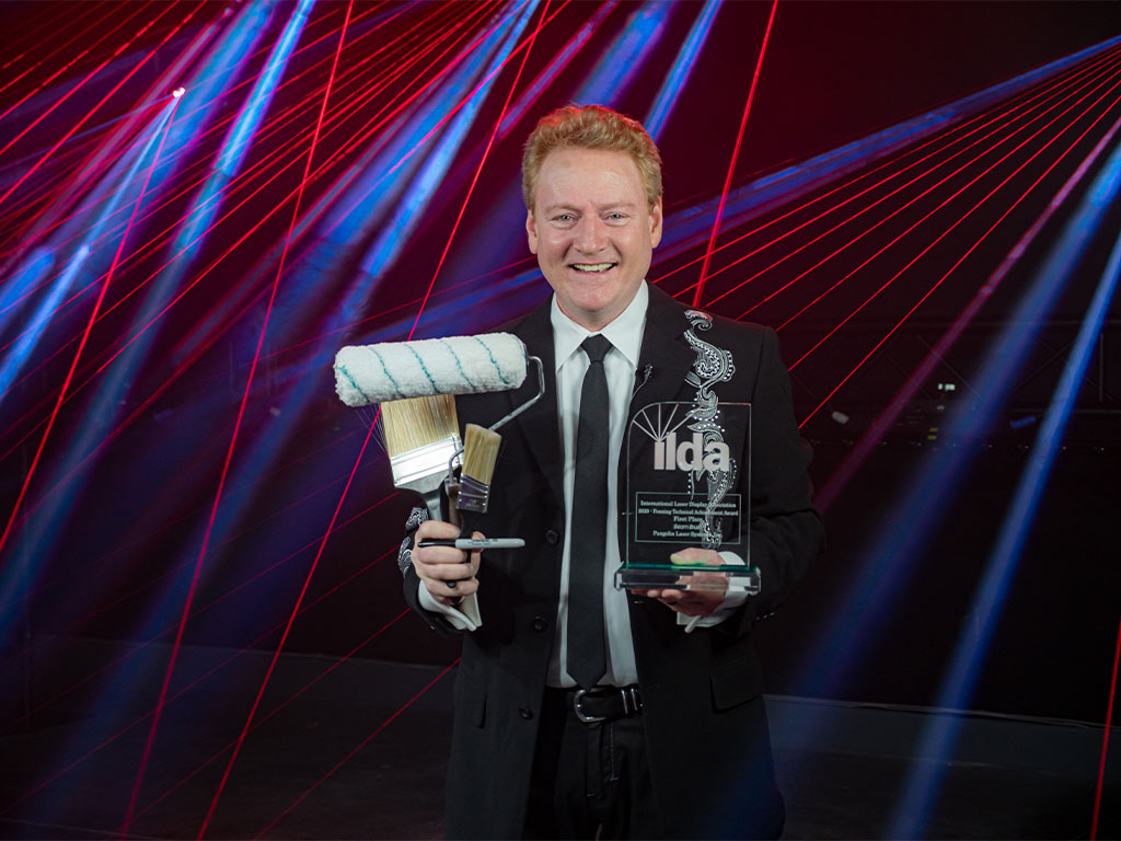 William Benner holding BeamBrush Award