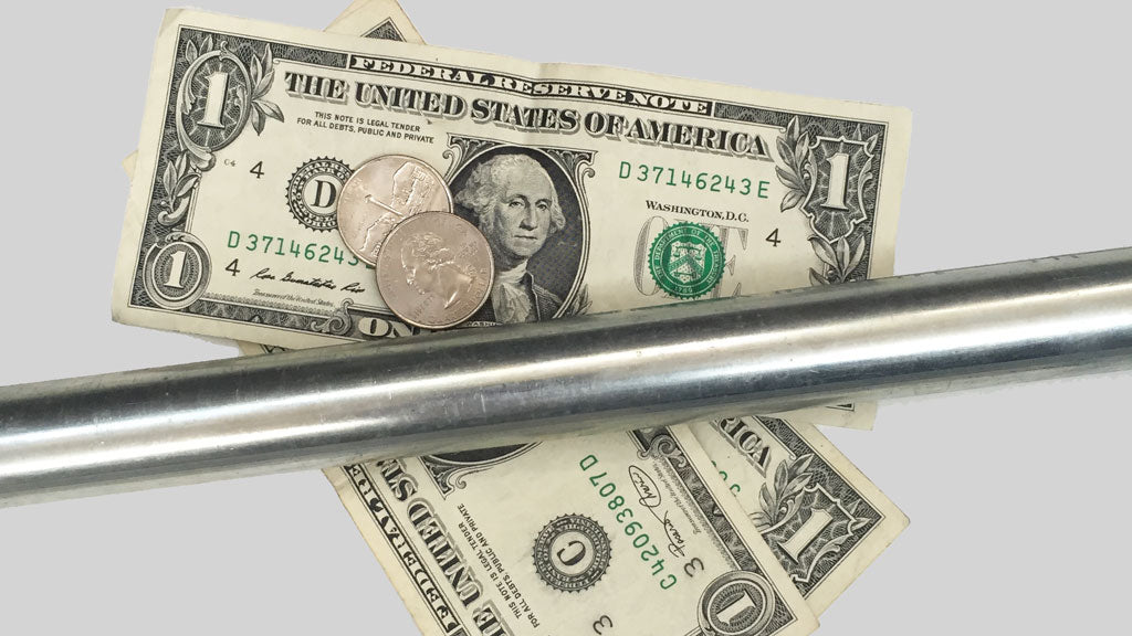 Steel conduit lying on a few dollar bills and loose change