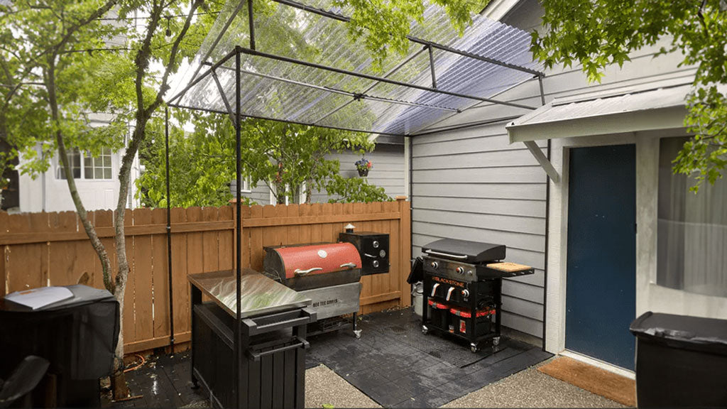 Custom conduit canopy built over top of a backyard grilling area