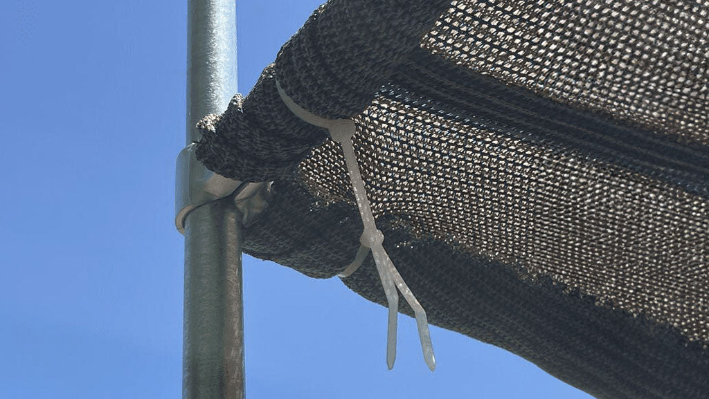 Zip ties securing a sunshade to a conduit frame