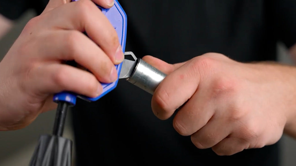 Man using reamer to deburr EMT Conduit end