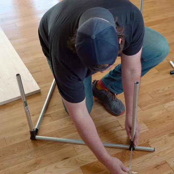Man Tightening Wrench On DIY Pipe Desk