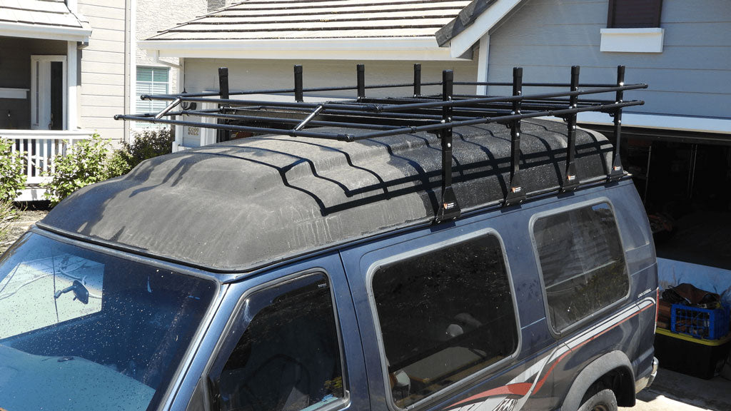 Ford Econoline van with a custom roof rack made with conduit and connectors