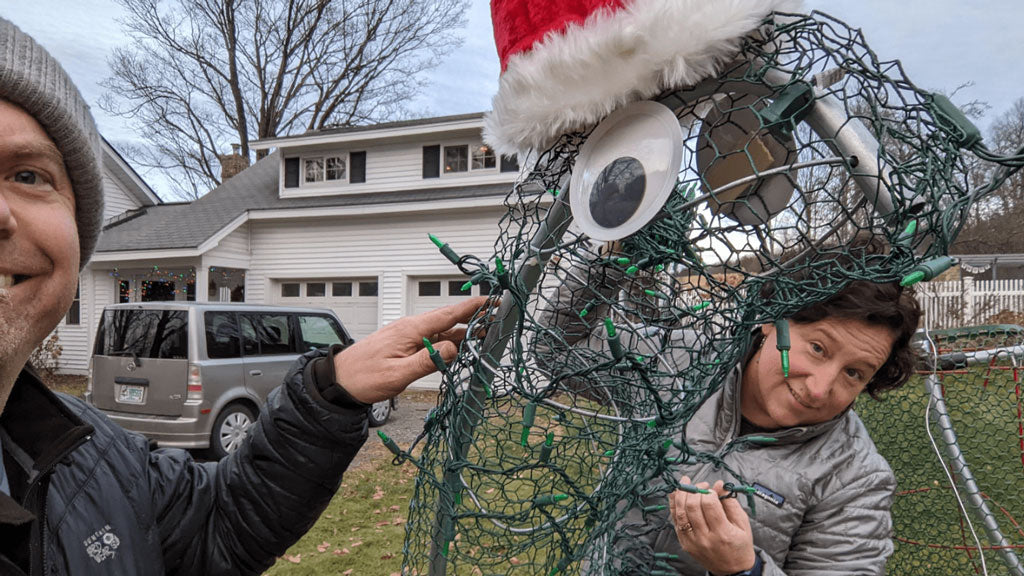 Chicken Wire, Googly Eyes, And Santa Hat Attached To Conduit Dinosaur