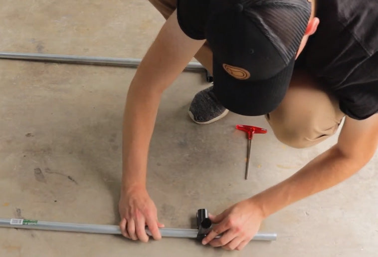 Man Assembling Pipe Connectors On EMT Conduit