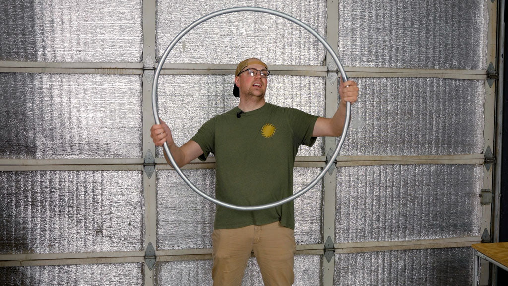 a builder holding a finished emt conduit circle