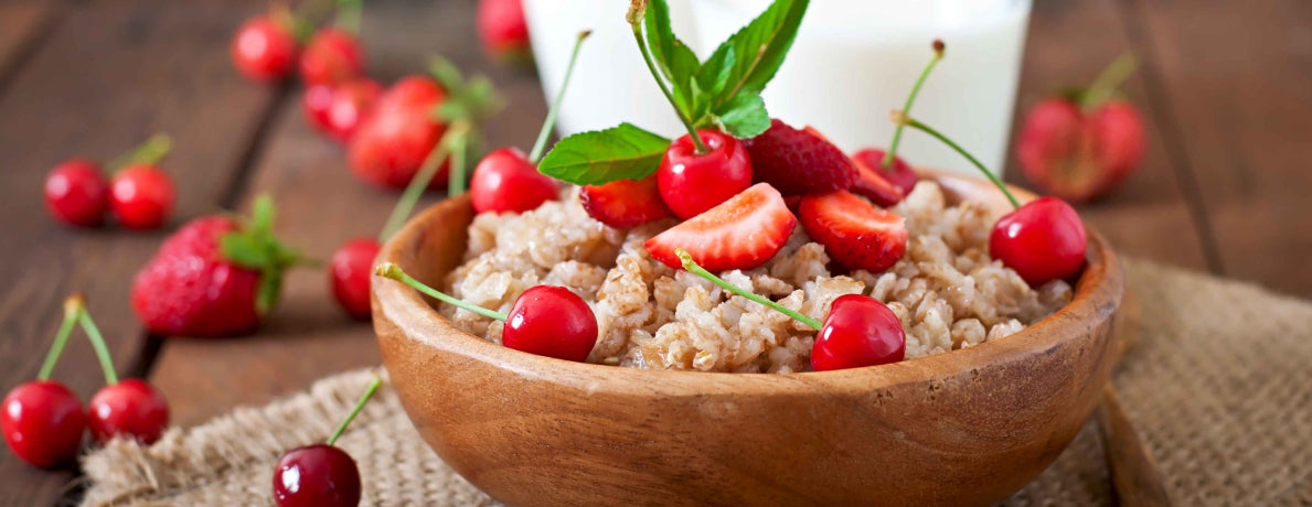 Bowl of oatmeal with cherries.