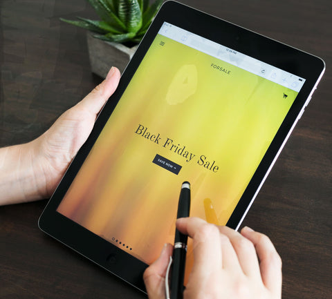 person shopping on tablet for handmade soap during Black Friday sale