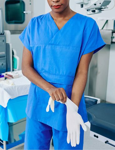 nurse putting on gloves