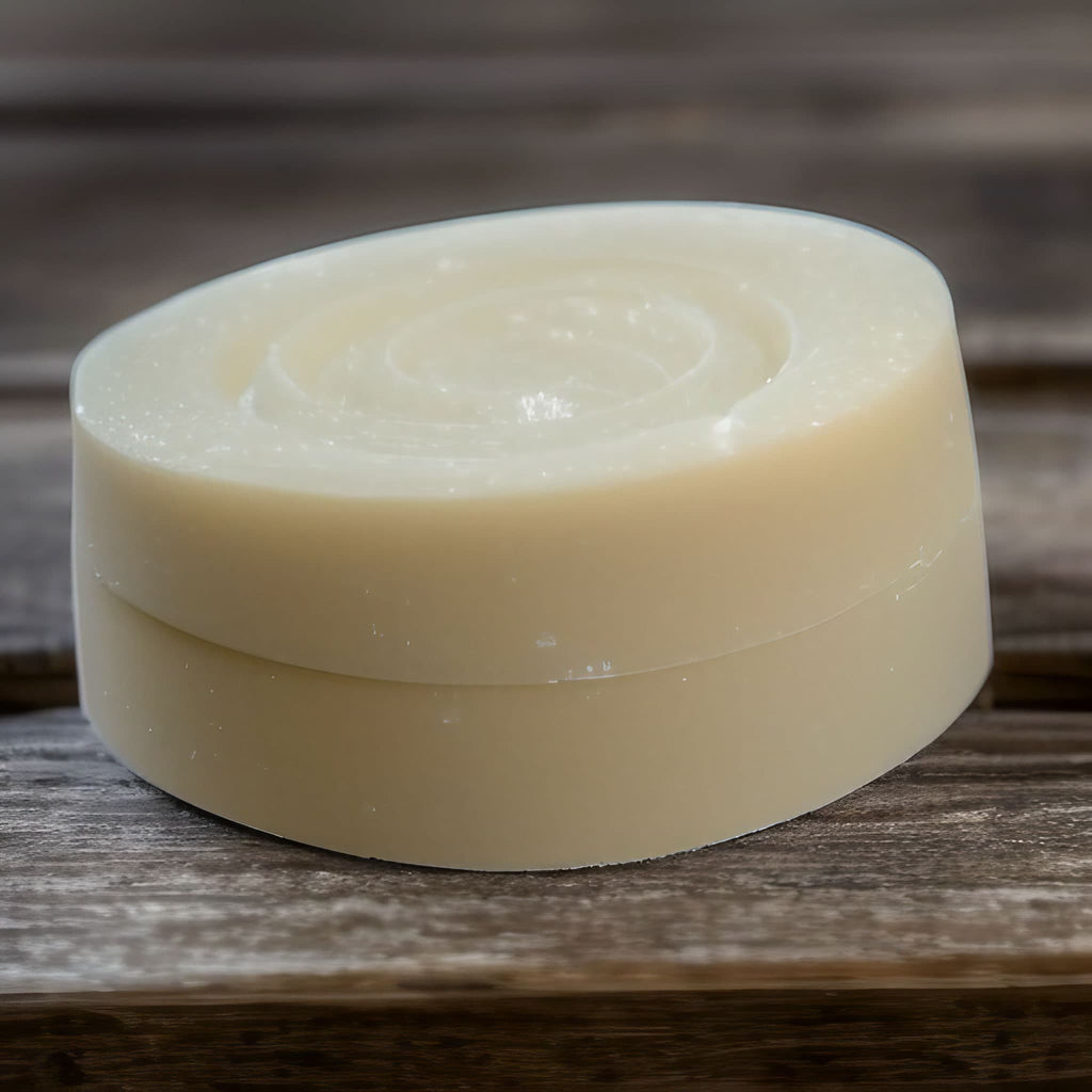 small round soap bar on a wooden soap dish with wide slats