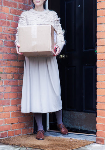 woman receiving package shipped to her with free domestic shipping