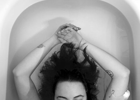 woman in bathtub with hair underwater