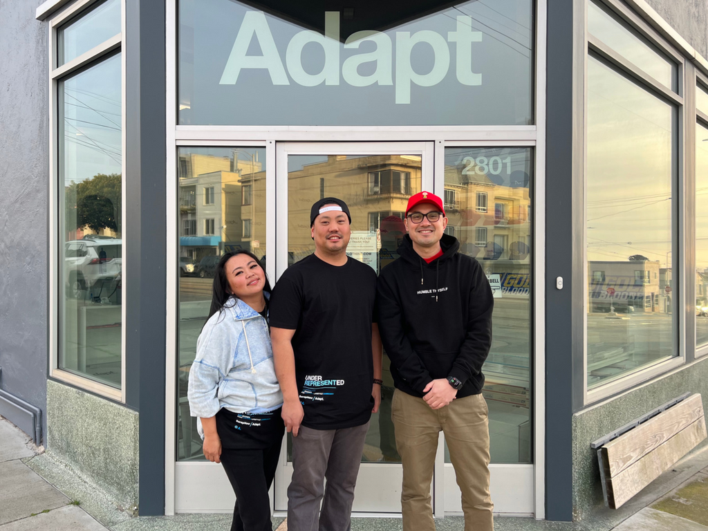 Sarap Now founders Kenny and Katrina Camarillo and Adapt founder Evan Lessler wearing limited-edition black “underrepresented” T-shirts