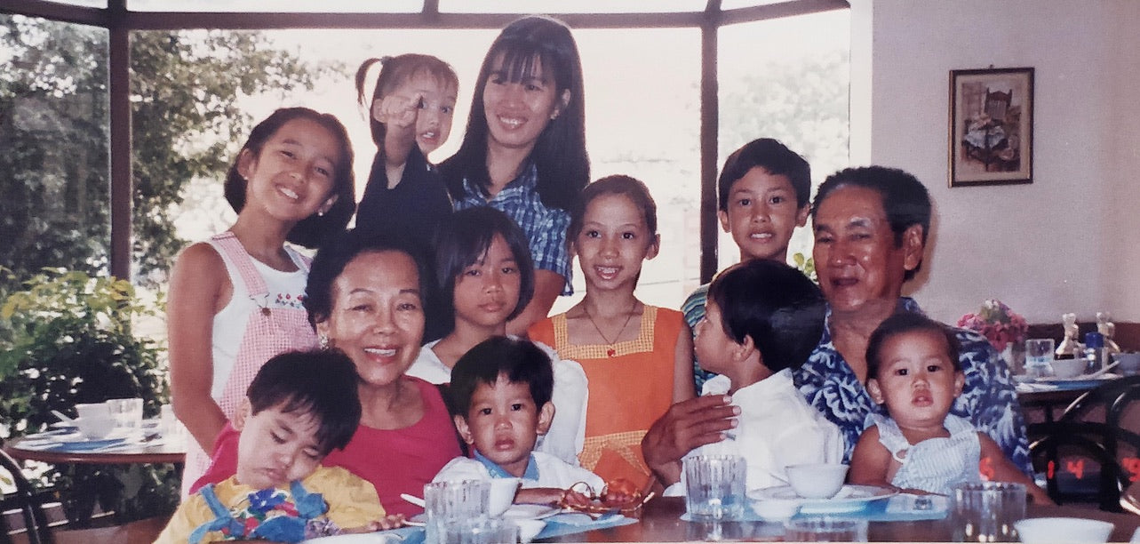 A childhood photo of Victoria and Miggy Reyes, the sibling co-founders of Narra, with family.