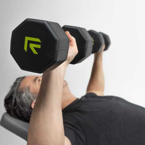 man doing dumbbell bench press exercise