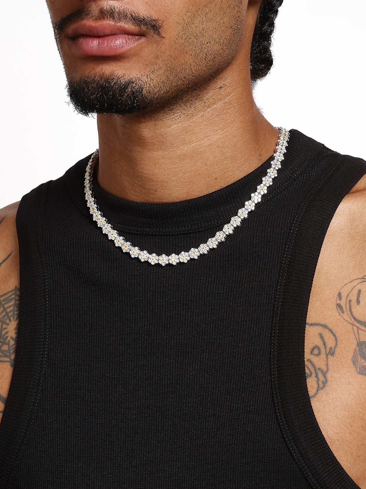 unique accessories for men. Man with mustache wearing black tank top and yellow daisy tennis chain