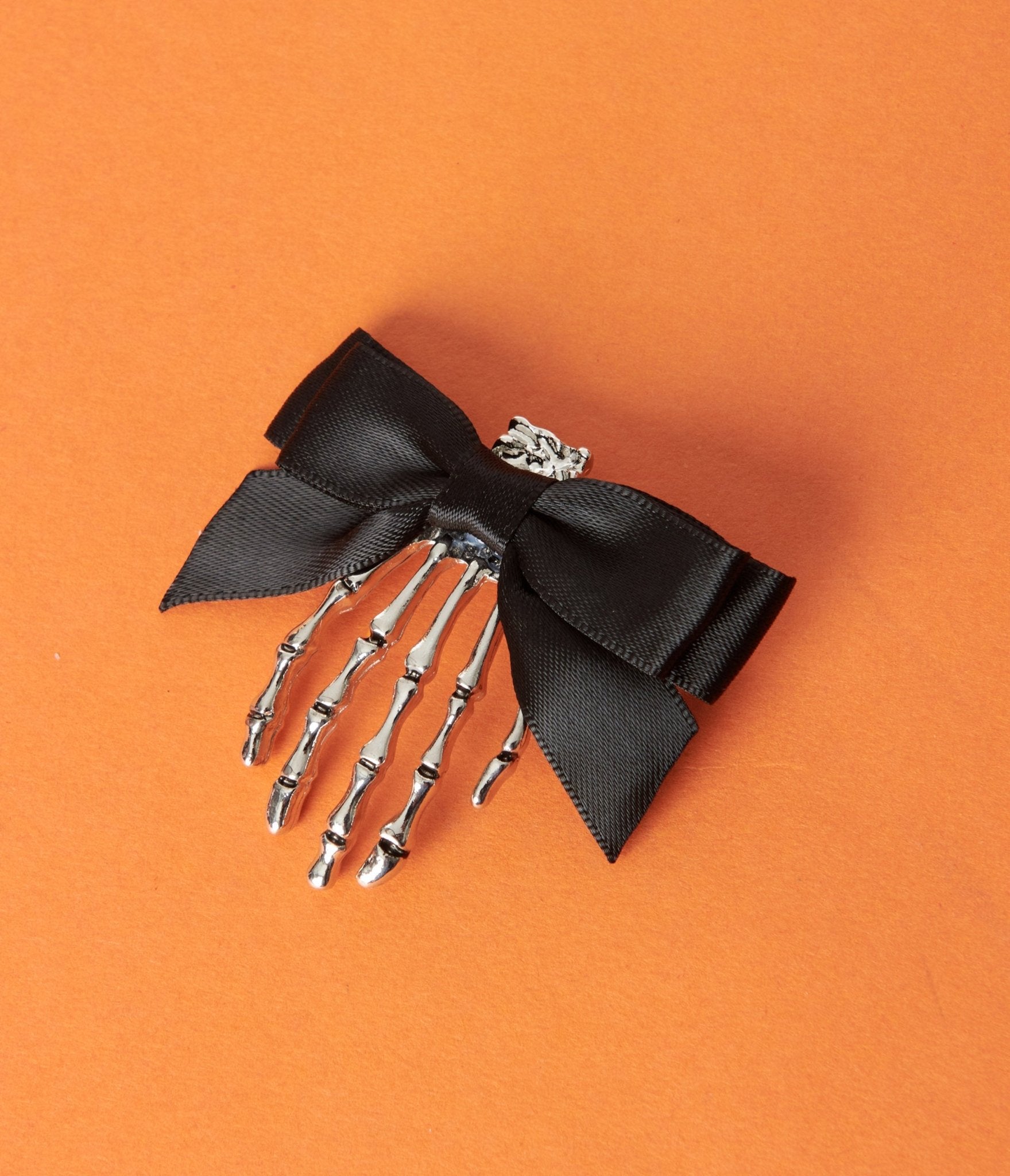 

Silver Skeleton Hand & Black Bow Hair Clip