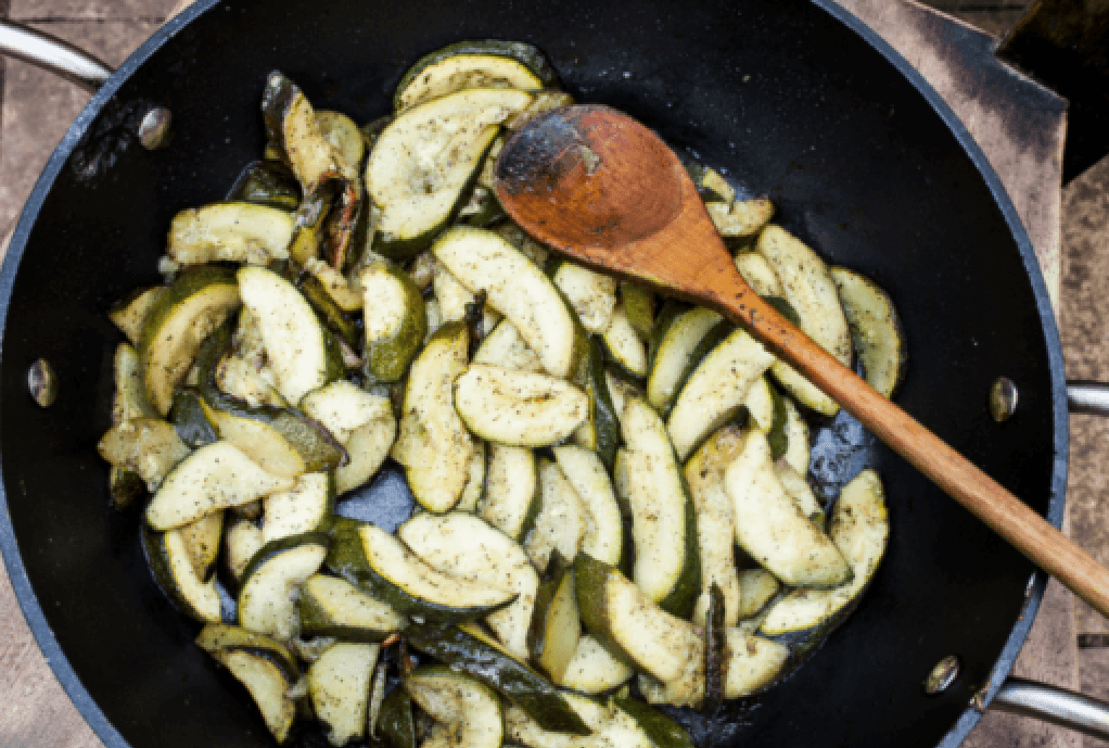 squash and zucchini cooking in sauté pan on stove