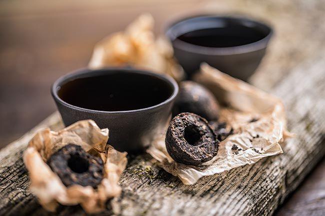 Cups of black tea with pressed tea leaves. Tanins that dry out gut